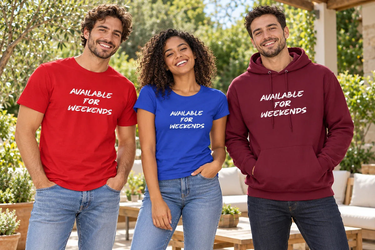 Three friends wearing Available For Weekends shirts in red and blue and a burgundy hoodie on an outdoor patio.