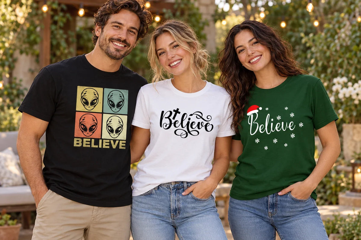 Three adults wearing Believe shirts with alien faces, a faith-inspired cross, and a Christmas Santa hat design in a garden.
